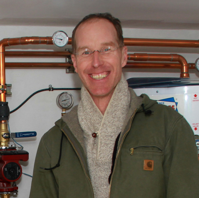 John Jesse in front of one of his earlier and favorite hot water boiler projects. Picture by Manny Becerra